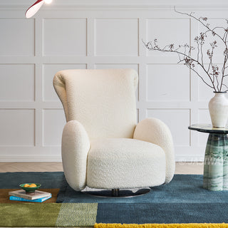 JASIWAY retro modern 360-degree swivel lounge chair featuring a sculptural curved silhouette and premium textured upholstery, showcasing a unique rounded backrest and barrel-style armrests, perfect as a stylish focal point for a contemporary living room, cozy bedroom nook, or executive study.-Three-quarter view