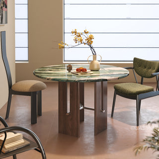 JASIWAY round dining table featuring a vibrant marble top with a polished finish, supported by a sculptural dark wood pedestal base with sleek metal cross-bar accents and an architectural open-frame storage design for modern kitchen interiors.-Front view