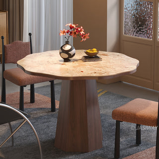 JASIWAY round dining table featuring a uniquely scalloped-edge sintered stone top, supported by a faceted sculptural pedestal base in a rich walnut wood finish, blending organic modern silhouettes with mid-century design elements for a dining room centerpiece.-Slight high-angle view of warm light