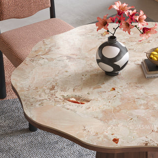 JASIWAY round dining table featuring a uniquely scalloped-edge sintered stone top, supported by a faceted sculptural pedestal base in a rich walnut wood finish, blending organic modern silhouettes with mid-century design elements for a dining room centerpiece.-Close-up of tabletop detail