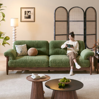 JASIWAY modern upholstered couch featuring a premium textured fabric over deeply tufted cushions, built on a sturdy mid-century walnut finish solid wood frame with exposed spindle arms, featuring a removable washable slipcover for an elegant yet functional living room seating solution.-Front view with model sitting