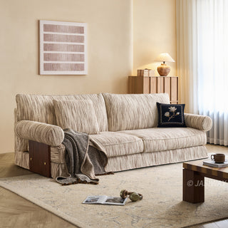 JASIWAY textured linen blend sofa, featuring a minimalist upholstery with a subtle linear weave, highlighting its plush, oversized bolsters and the architectural solid wood side panels, perfect for contemporary living rooms.-Three-quarter view