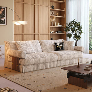 JASIWAY textured linen blend sofa, featuring a minimalist upholstery with a subtle linear weave, highlighting its plush, oversized bolsters and the architectural solid wood side panels, perfect for contemporary living rooms.-Three-quarter view