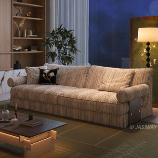 JASIWAY textured linen blend sofa, featuring a minimalist upholstery with a subtle linear weave, highlighting its plush, oversized bolsters and the architectural solid wood side panels, perfect for contemporary living rooms.-Diagonal view of warm lighting
