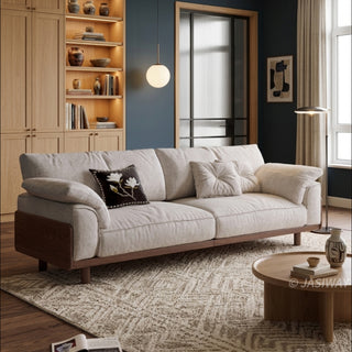 JASIWAY mid-century modern 3-seater sofa featuring premium top-grain leather upholstery with hand-stitched detailing, plush oversized armrests, and a sturdy solid wood exposed frame base in a walnut finish for a luxury living room aesthetic.-Three-quarter view