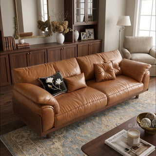 JASIWAY mid-century modern 3-seater sofa featuring premium top-grain leather upholstery with hand-stitched detailing, plush oversized armrests, and a sturdy solid wood exposed frame base in a walnut finish for a luxury living room aesthetic.-High-angle view