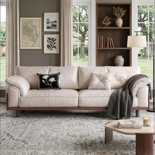 JASIWAY mid-century modern 3-seater sofa featuring premium top-grain leather upholstery with hand-stitched detailing, plush oversized armrests, and a sturdy solid wood exposed frame base in a walnut finish for a luxury living room aesthetic.-Front view