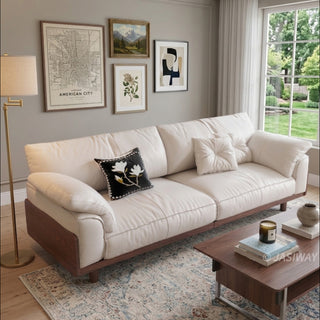 JASIWAY mid-century modern 3-seater sofa featuring premium top-grain leather upholstery with hand-stitched detailing, plush oversized armrests, and a sturdy solid wood exposed frame base in a walnut finish for a luxury living room aesthetic.-High-angle view