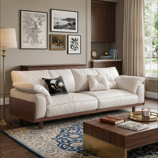 JASIWAY mid-century modern 3-seater sofa featuring premium top-grain leather upholstery with hand-stitched detailing, plush oversized armrests, and a sturdy solid wood exposed frame base in a walnut finish for a luxury living room aesthetic.-Three-quarter view