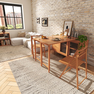 Wide-angle lifestyle shot of a modern natural wood extendable dining set and sideboard with fluted glass doors, staged in a cozy apartment with an exposed brick wall and large windows.