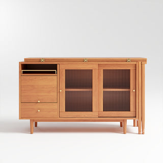 Studio product shot of a modern natural wood sideboard cabinet featuring fluted glass sliding doors, drawers, and folded extension table storage against a clean white background.
