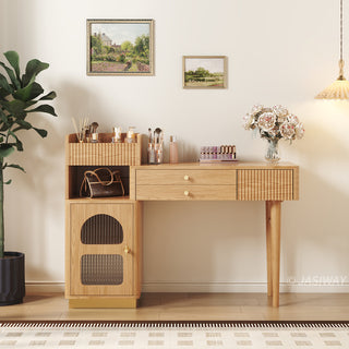Angled lifestyle view of a modern wooden vanity desk with fluted drawers, open shelving, and a cabinet in a warm bedroom setting.