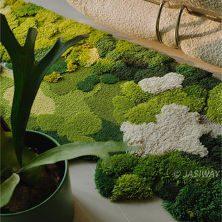 RINGCHEN hand-tufted round area rug with a 3D forest moss design, featuring sculptural high-low pile in shades of deep emerald, sage green, and earthy grey to mimic a natural forest floor.-Low-angle perspective