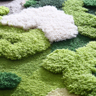 RINGCHEN hand-tufted round area rug with a 3D forest moss design, featuring sculptural high-low pile in shades of deep emerald, sage green, and earthy grey to mimic a natural forest floor.-Extreme close-up