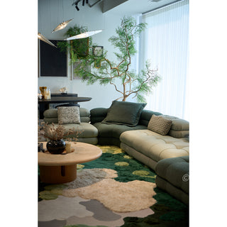 RINGCHEN hand-tufted round area rug with a 3D forest moss design, featuring sculptural high-low pile in shades of deep emerald, sage green, and earthy grey to mimic a natural forest floor.-Full interior view