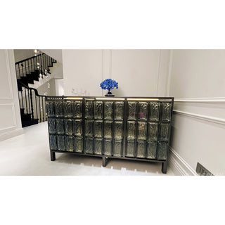RINGCHEN architectural glass block sideboard, modern luxury credenza featuring textured amber cast glass panels and solid wood frame, minimalist entryway console and dining room buffet with industrial black stainless steel metal legs.-Front view in interior