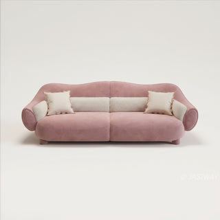 RINGCHEN modern luxury blush pink curved cloud sofa featuring a sculptural shell-inspired silhouette, premium deep-seat upholstered velvet fabric with decorative cream boucle lumbar pillows and ruffled accent cushions for a high-end designer living room aesthetic.-Front studio view