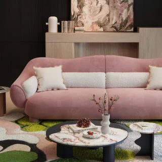 RINGCHEN modern luxury blush pink curved cloud sofa featuring a sculptural shell-inspired silhouette, premium deep-seat upholstered velvet fabric with decorative cream boucle lumbar pillows and ruffled accent cushions for a high-end designer living room aesthetic.-Front view