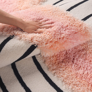 RINGCHEN petal pink and obsidian abstract round rug featuring a high-low tufted texture and organic circular ripples, showcases a hand-drawn tree ring motif with soft pink shaggy edges and crisp black line, blending modern minimalism with poetic visual storytelling.-Detail shot