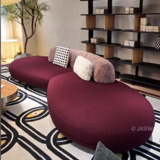 RINGCHEN modern minimalist pebble sofa, luxury contemporary modular couch featuring a curved pebble-shaped silhouette, upholstered in premium matte velvet with a textured bouclé backrest, perfect for sophisticated living room interiors.-Diagonal view