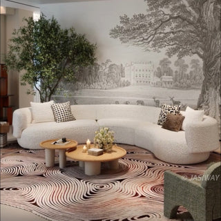 RINGCHEN luxury curved bouclé sectional sofa featuring a modular crescent moon design, upholstered in premium white cloud-textured bouclé fabric. This designer modular couch showcases a minimalist semi-circular silhouette, low-profile frame, and soft organic lines, ideal for modern luxury living rooms and contemporary open-concept spaces.-Three quarter view