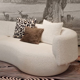 RINGCHEN luxury curved bouclé sectional sofa featuring a modular crescent moon design, upholstered in premium white cloud-textured bouclé fabric. This designer modular couch showcases a minimalist semi-circular silhouette, low-profile frame, and soft organic lines, ideal for modern luxury living rooms and contemporary open-concept spaces.-Close-up of armrest