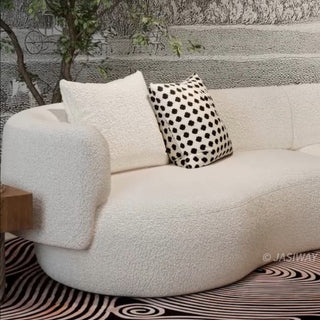 RINGCHEN luxury curved bouclé sectional sofa featuring a modular crescent moon design, upholstered in premium white cloud-textured bouclé fabric. This designer modular couch showcases a minimalist semi-circular silhouette, low-profile frame, and soft organic lines, ideal for modern luxury living rooms and contemporary open-concept spaces.-Close-up of armrest