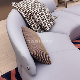 RINGCHEN luxury curved sectional sofa featuring a modular cloud couch silhouette with a mix of smooth premium leather and textured bouclé fabric. The sculptural design includes a distinctive rotating lounge seat, an integrated low-profile chaise, and a sweeping ergonomic backrest, showcasing a seamless blend of modern artistry and functional seating for high-end designer living rooms. -Close-up of backrest
