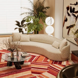 RINGCHEN luxury curved sofa featuring a sculptural serpentine silhouette and cloud-like contoured backrest, upholstered in a premium textured woven fabric with a detailed oatmeal and golden-hued interlaced pattern, designed for high-end organic modern living rooms and designer-led residential interiors.-Three quarter view
