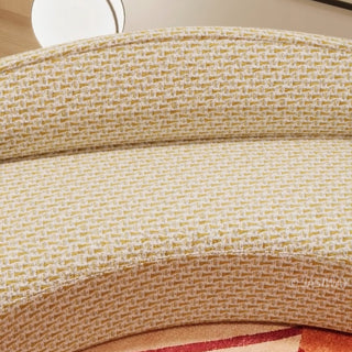 RINGCHEN luxury curved sofa featuring a sculptural serpentine silhouette and cloud-like contoured backrest, upholstered in a premium textured woven fabric with a detailed oatmeal and golden-hued interlaced pattern, designed for high-end organic modern living rooms and designer-led residential interiors.-Close-up of fabric texture