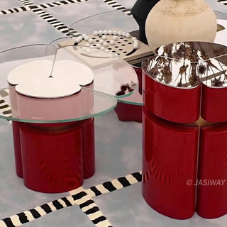 RINGCHEN modern cluster coffee table set featuring three modular nesting tables with premium tempered glass tops and sculptural petal-shaped metal bases in a bold red finish with gold accents. This luxury living room furniture set showcases a sophisticated clover-like silhouette and a sleek, high-gloss industrial design ideal for upscale interior decor.-High-angle medium shot