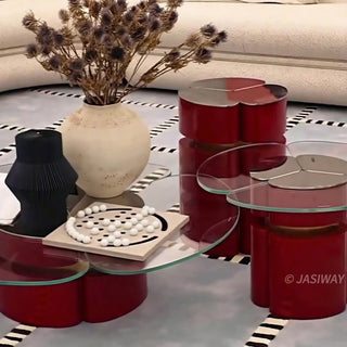 RINGCHEN modern cluster coffee table set featuring three modular nesting tables with premium tempered glass tops and sculptural petal-shaped metal bases in a bold red finish with gold accents. This luxury living room furniture set showcases a sophisticated clover-like silhouette and a sleek, high-gloss industrial design ideal for upscale interior decor.-High-angle view