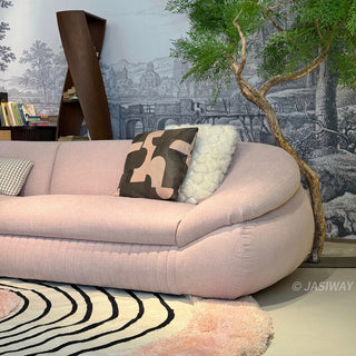 RINGCHEN modern curved cloud sofa featuring premium blush textured upholstery, highlighted by its signature sculptural low-profile silhouette, channel-tufted base detailing, and deep-seated organic cushioning for a high-end minimalist living room aesthetic.-Medium shot