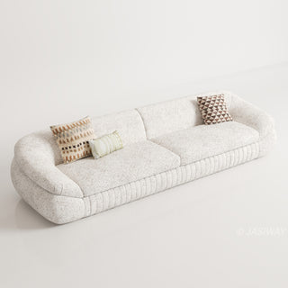 RINGCHEN modern curved cloud sofa featuring premium blush textured upholstery, highlighted by its signature sculptural low-profile silhouette, channel-tufted base detailing, and deep-seated organic cushioning for a high-end minimalist living room aesthetic.-High-angle studio view