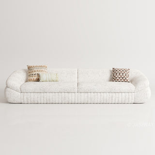 RINGCHEN modern curved cloud sofa featuring premium blush textured upholstery, highlighted by its signature sculptural low-profile silhouette, channel-tufted base detailing, and deep-seated organic cushioning for a high-end minimalist living room aesthetic.-Front view