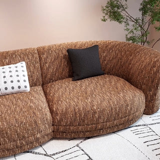RINGCHEN modern Italian modular sectional sofa featuring a sculptural curved design and deep seat cushions, upholstered in a textured fabric. This low-profile luxury couch showcasing high-end craftsmanship, organic biomorphic contours, and an integrated small side table, designed for contemporary upscale living room decor and premium home styling.-Fabric detail