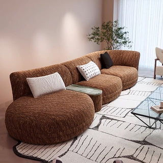 RINGCHEN modern Italian modular sectional sofa featuring a sculptural curved design and deep seat cushions, upholstered in a textured fabric. This low-profile luxury couch showcasing high-end craftsmanship, organic biomorphic contours, and an integrated small side table, designed for contemporary upscale living room decor and premium home styling.-Diagonal view