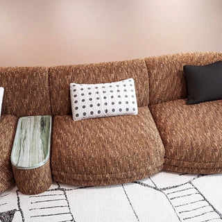 RINGCHEN modern Italian modular sectional sofa featuring a sculptural curved design and deep seat cushions, upholstered in a textured fabric. This low-profile luxury couch showcasing high-end craftsmanship, organic biomorphic contours, and an integrated small side table, designed for contemporary upscale living room decor and premium home styling.-High-angle view