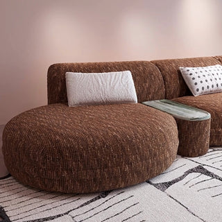 RINGCHEN modern Italian modular sectional sofa featuring a sculptural curved design and deep seat cushions, upholstered in a textured fabric. This low-profile luxury couch showcasing high-end craftsmanship, organic biomorphic contours, and an integrated small side table, designed for contemporary upscale living room decor and premium home styling.-Close-up of chaise lounge