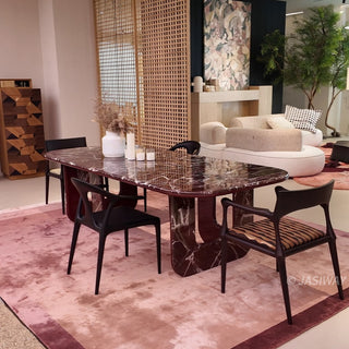 RINGCHEN modern minimalist oval dining table featuring a luxurious lava red marble and engineered solid wood, supported by unique sculptural legs with a high-gloss burgundy interior and matching marble exterior, perfect for elegant luxury dining room centerpieces.-Wide diagonal view