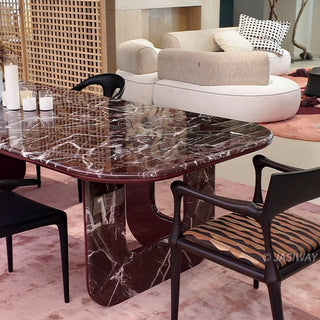 RINGCHEN modern minimalist oval dining table featuring a luxurious lava red marble and engineered solid wood, supported by unique sculptural legs with a high-gloss burgundy interior and matching marble exterior, perfect for elegant luxury dining room centerpieces.-Medium shot