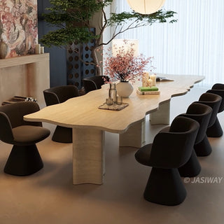 RINGCHEN organic modern dining table featuring a premium cream-toned travertine tabletop with a distinctive, scalloped live-edge silhouette. The sculptural rectangular design showcases the natural porous texture of authentic stone, supported by robust, monolithic block pedestals, ideal for luxury dining environments.-Three quarter view