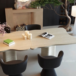RINGCHEN organic modern dining table featuring a premium cream-toned travertine tabletop with a distinctive, scalloped live-edge silhouette. The sculptural rectangular design showcases the natural porous texture of authentic stone, supported by robust, monolithic block pedestals, ideal for luxury dining environments.-High-angle view