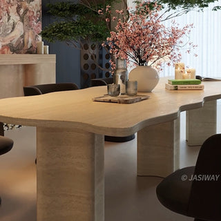 RINGCHEN organic modern dining table featuring a premium cream-toned travertine tabletop with a distinctive, scalloped live-edge silhouette. The sculptural rectangular design showcases the natural porous texture of authentic stone, supported by robust, monolithic block pedestals, ideal for luxury dining environments.-Low-angle close up of edge