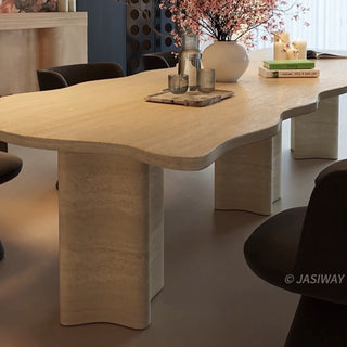 RINGCHEN organic modern dining table featuring a premium cream-toned travertine tabletop with a distinctive, scalloped live-edge silhouette. The sculptural rectangular design showcases the natural porous texture of authentic stone, supported by robust, monolithic block pedestals, ideal for luxury dining environments.-Low-angle view of base