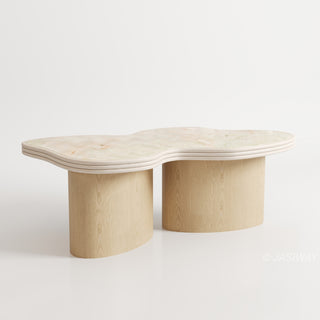 RINGCHEN sculptural cloud-shaped marble dining table featuring a luxury irregular cream-toned marble top with natural veining, supported by a sturdy dual solid wood pedestal base with a light natural oak finish, designed for modern minimalist and high-end designer dining rooms. -Three quarter view