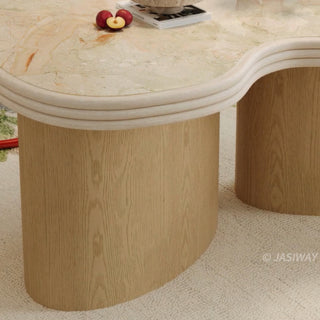 RINGCHEN sculptural cloud-shaped marble dining table featuring a luxury irregular cream-toned marble top with natural veining, supported by a sturdy dual solid wood pedestal base with a light natural oak finish, designed for modern minimalist and high-end designer dining rooms. -Close-up of pedestal base