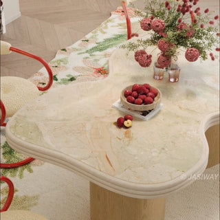 RINGCHEN sculptural cloud-shaped marble dining table featuring a luxury irregular cream-toned marble top with natural veining, supported by a sturdy dual solid wood pedestal base with a light natural oak finish, designed for modern minimalist and high-end designer dining rooms. -High-angle view of tabletop