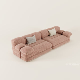 RINGCHEN luxury sculptural cluster jacquard sofa featuring a curved cloud-like silhouette, upholstered in premium textured designer fabric with a sophisticated pink and white micro-pattern, showcasing a low-profile modular frame, deep-seated comfort, and distinctive leather strap detailing on the rounded armrests for high-end living room interiors.-High-angle view