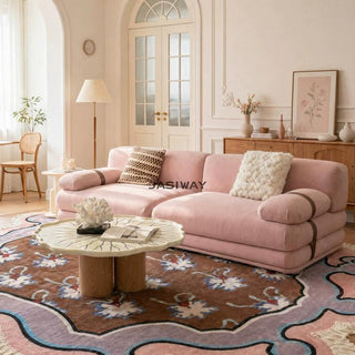 RINGCHEN luxury sculptural cluster jacquard sofa featuring a curved cloud-like silhouette, upholstered in premium textured designer fabric with a sophisticated pink and white micro-pattern, showcasing a low-profile modular frame, deep-seated comfort, and distinctive leather strap detailing on the rounded armrests for high-end living room interiors.-Three quarter view